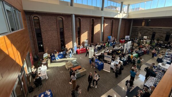 Employer tables lined up for healthcare career fair.