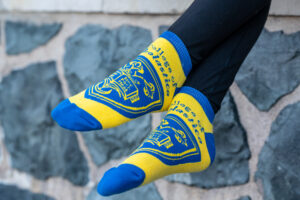 Close-up of St. Scholastica branded ankle socks.