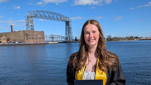 Sr. Scholastica Leadership Award winner Ada Krueger in front of Duluth's lift bridge.