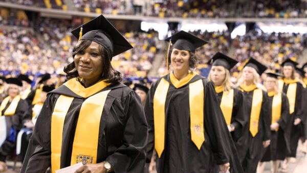 St. Scholastica graduate students walking at Commencement.