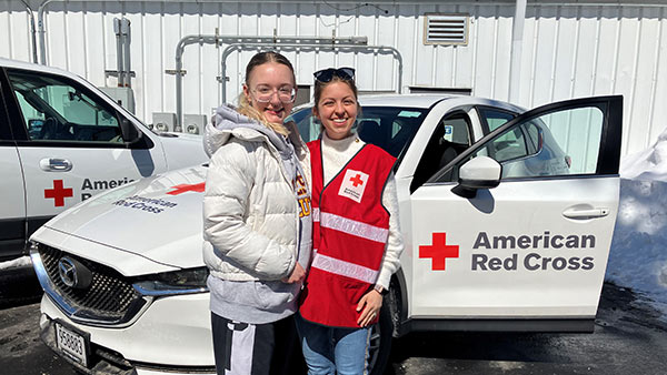 Photo of Amy Leopold and friend Anji out doing smoke alarm canvassing.