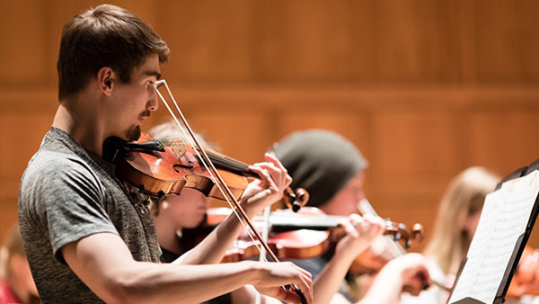 Students play in orchestra