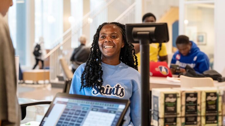 St. Scholastica student orders food at the Seekers Cafe.