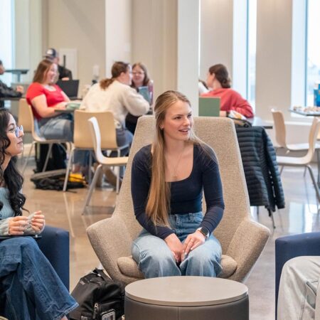 Group of St. Scholastica students chatting in the Student Center.