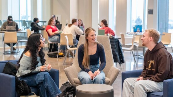 Group of St. Scholastica students chatting in the Student Center.