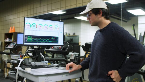 St. Scholastica exercise physiology student Sam Haynes shows results of research