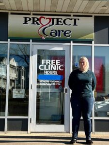 Tiffany Schleppegrell poses in front of the Free Clinic