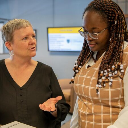 St. Scholastica staff member talking to a student