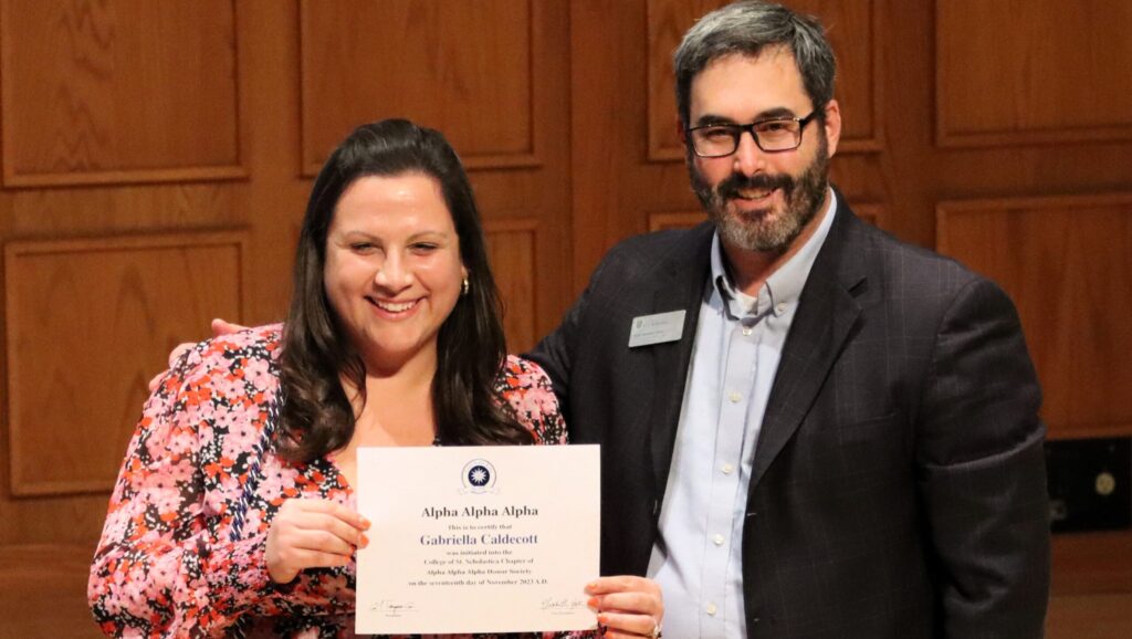 Ryan Sandefer presenting Gabriella (Herrera) Caldecott ’13 with the 2023 First-Generation Alumni Award at the Tri Alpha induction ceremony.