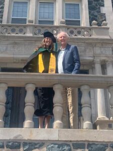 Kim Watkins and her father in front of Tower Hall at commencement.