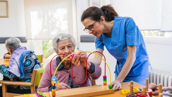 St. Scholastica Occupational therapy student works with an elderly woman.