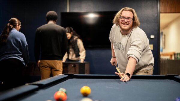 St. Scholastica students playing billiards games.