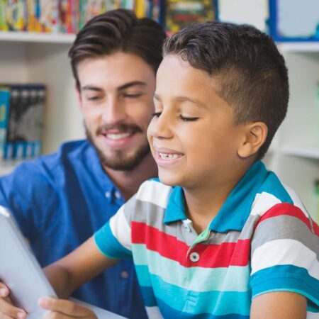 A photo of a teacher helping a student read