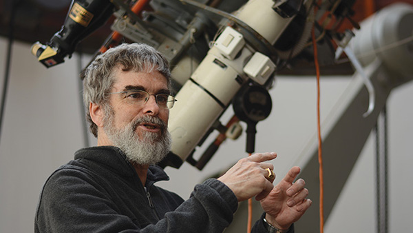 Br. Guy Consolmagno with a telescope