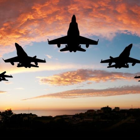 Military planes flying in a pattern.