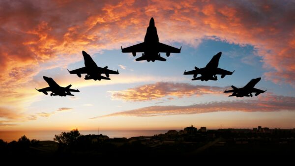 Military planes flying in a pattern.