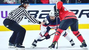 Alex Clarke refereeing a hockey game.