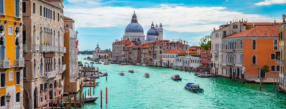 A scenic city view with boats on a river in Venice.