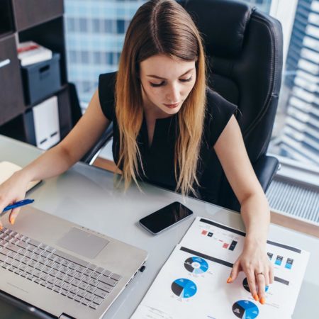 Business woman working in an office reviewing data.