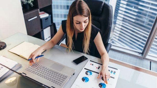 Business woman working in an office reviewing data.