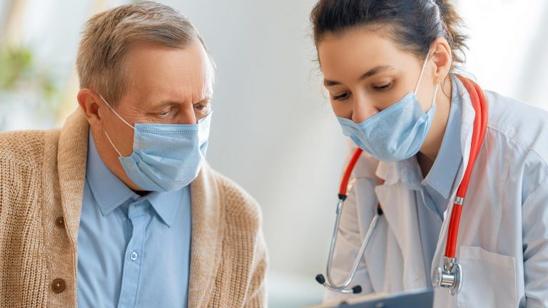 Doctor showing a patient their medical records.