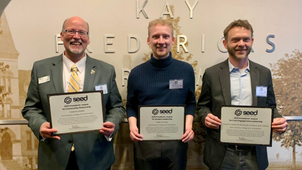 Michael Wendinger, Owen Erickson and Tim Lorek hold awards from Seed Coalition.