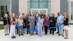 Barbara McDonald and Matt Baumgartner pose with a group at the Student Center Opening.