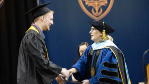 President McDonald with Owen Erickson at his commencement ceremony.