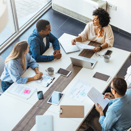 Coworkers talking through business tactics at a meeting.