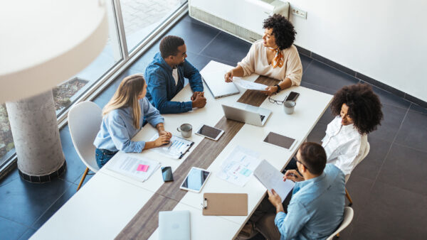 Coworkers talking through business tactics at a meeting.