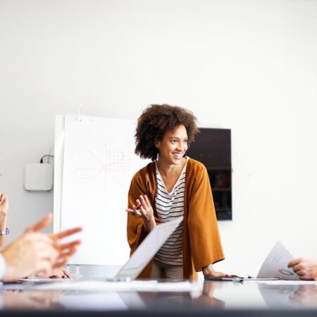 A group of individuals sitting at a conference table discussing a project.