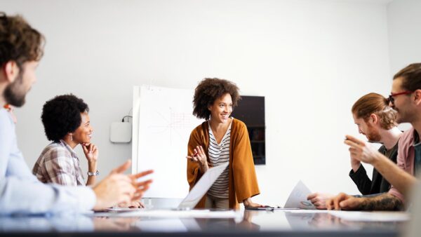 A group of individuals sitting at a conference table discussing a project.