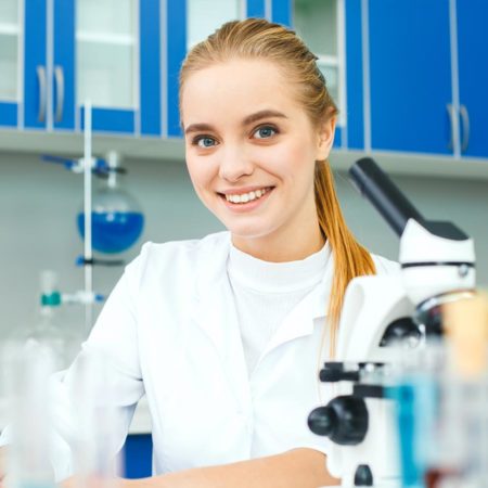 Student working on a laptop in a chemistry lab.