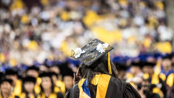 Graduation cap in focus "And the rest is history. Class of 2025"