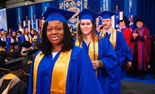 Students walking to the stage during the 2019 St. Scholastica Commencement.