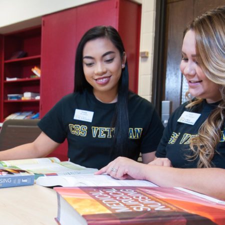 Two veterans studying and obtaining their degree at St. Scholastica.