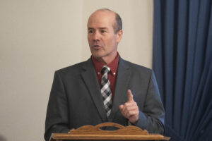 IRE Director Ron Ulseth speaks at podium.