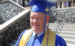 Don Claveau on the steps of St. Scholastica during Commencement.
