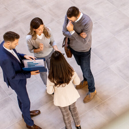 A young leader speaking to a group of corporate professionals.