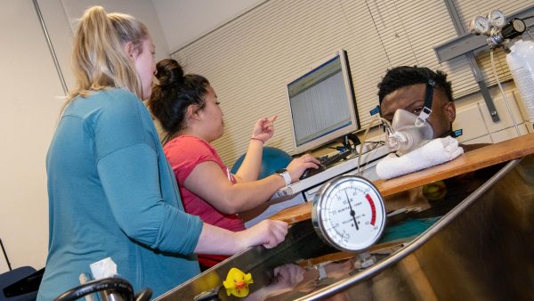 Students performing experiments in an exercise physiology lab at St. Scholastica
