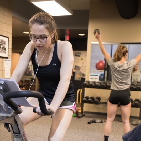 Students working out in St. Scholastica's Burns Wellness Commons fitness center.