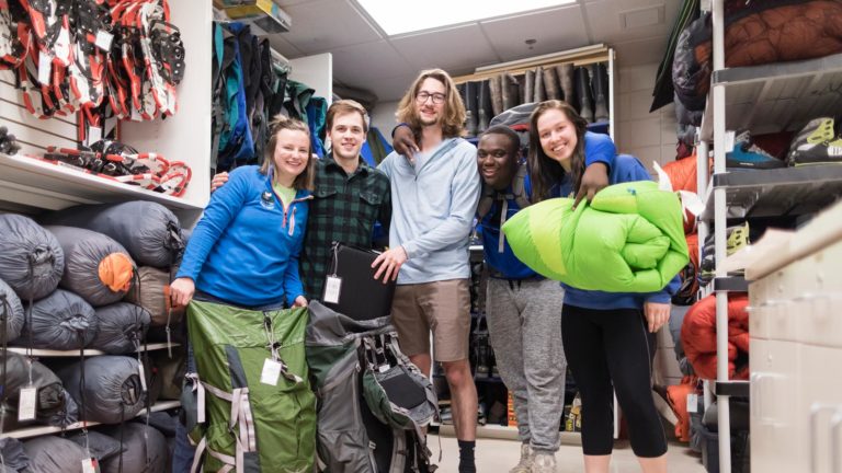 St. Scholastica students packing up gear in the Outdoor Pursuit office.