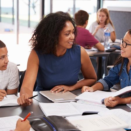 Teacher working with students in a classroom.