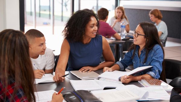 Teacher working with students in a classroom.