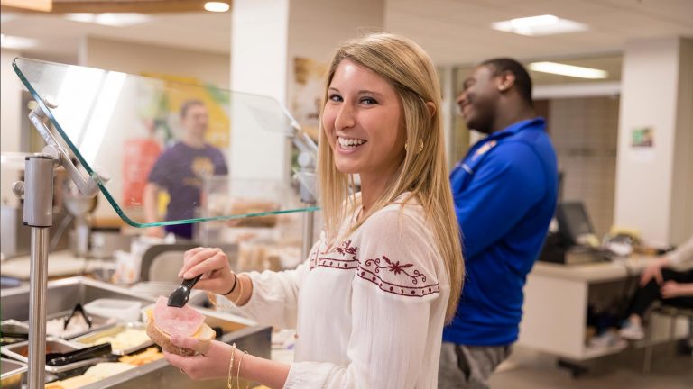 St. Scholastica students getting food in Greenview Dining Room.