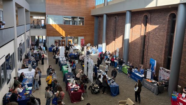 Employer tables lined up for healthcare career fair.