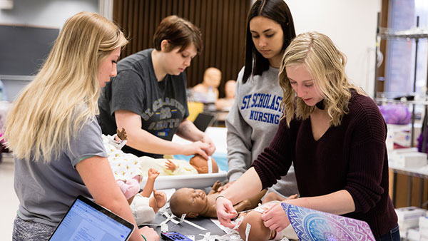 St. Scholastica nursing students working in a lab setting.