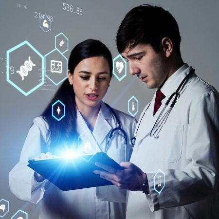Doctors looking at a mobile device looking at healthcare data.