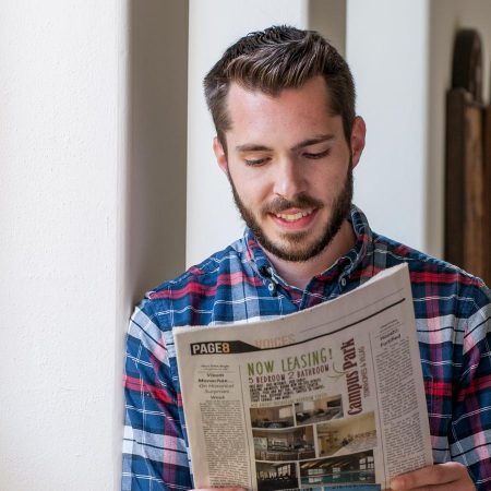 Thomas Gallegos reading The Cable newspaper