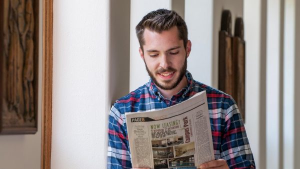 Thomas Gallegos reading The Cable newspaper